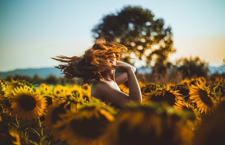 woman standing in a sunflower field by Matteo Vistocco?width=719&height=464&fit=crop&auto=webp