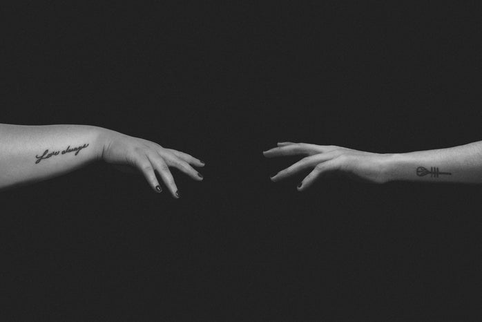 grayscale photos of people stretching hands