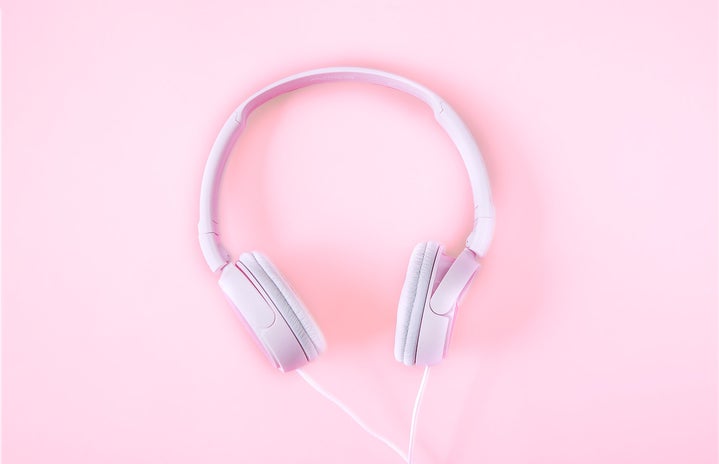 Pink headphones against a pink background