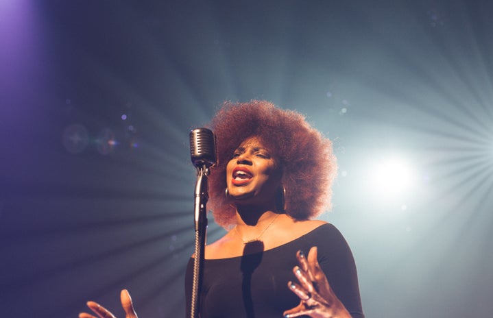 woman singing on stage by Josh Rocklage on Unsplash?width=719&height=464&fit=crop&auto=webp