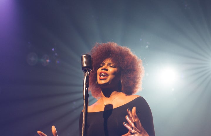 woman singing on stage by Josh Rocklage on Unsplash?width=719&height=464&fit=crop&auto=webp