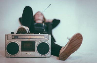 woman laying down with her foot on a radio