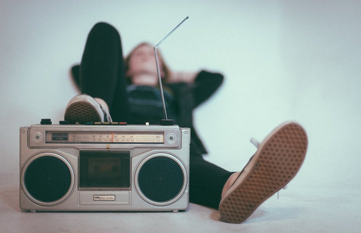woman laying down with her foot on a radio