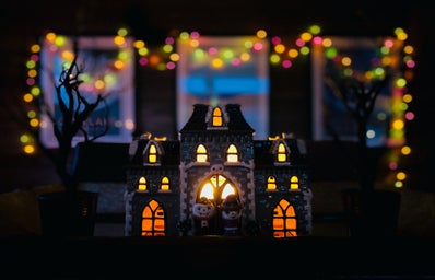 Mini halloween house figure in front of a Big house