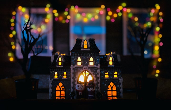 Mini halloween house figure in front of a Big house