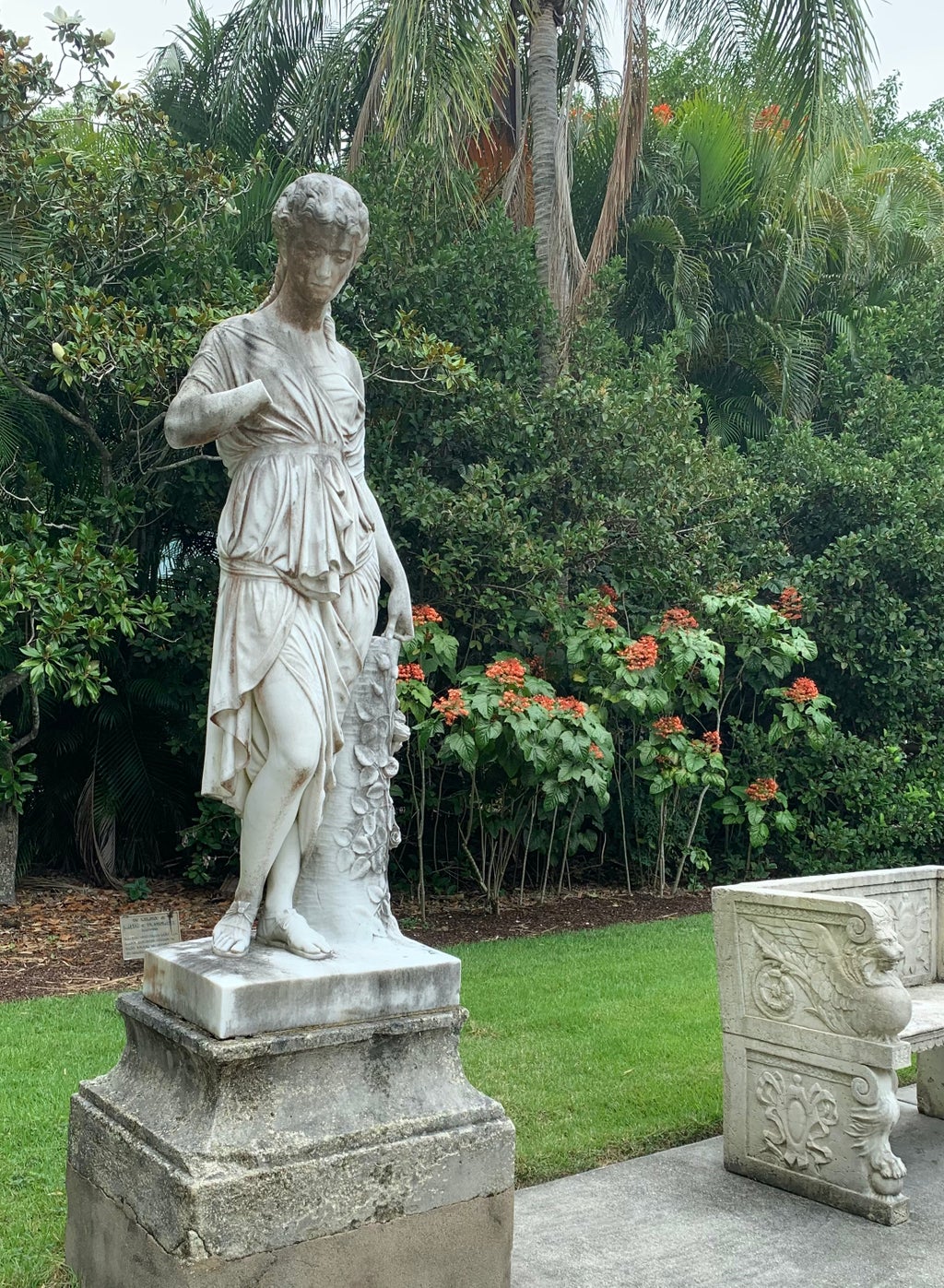 A stone statue of a woman in the Secret Garden at the Ringling Museum of Art in Sarasota, Florida