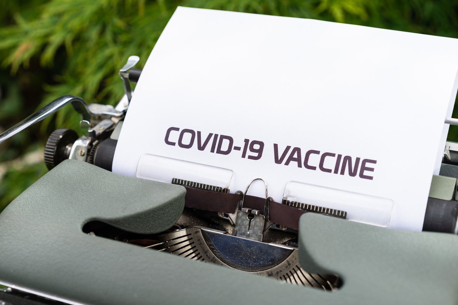 "COVID-19 VACCINE" typed on paper in a typewriter