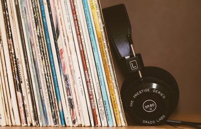 headphones leaning against record albums