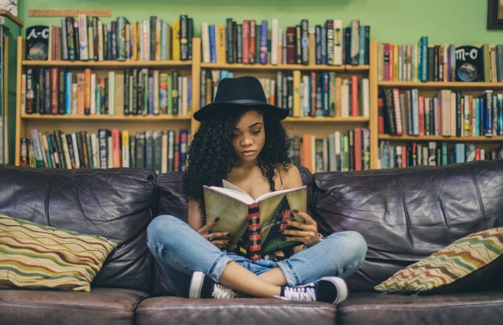 Woman reading a book on the couch