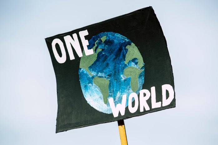 Sign that reads \"One World\" at climate change protest in Germany