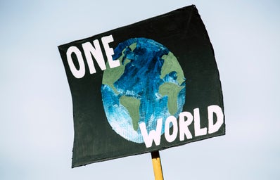 Sign that reads \"One World\" at climate change protest in Germany