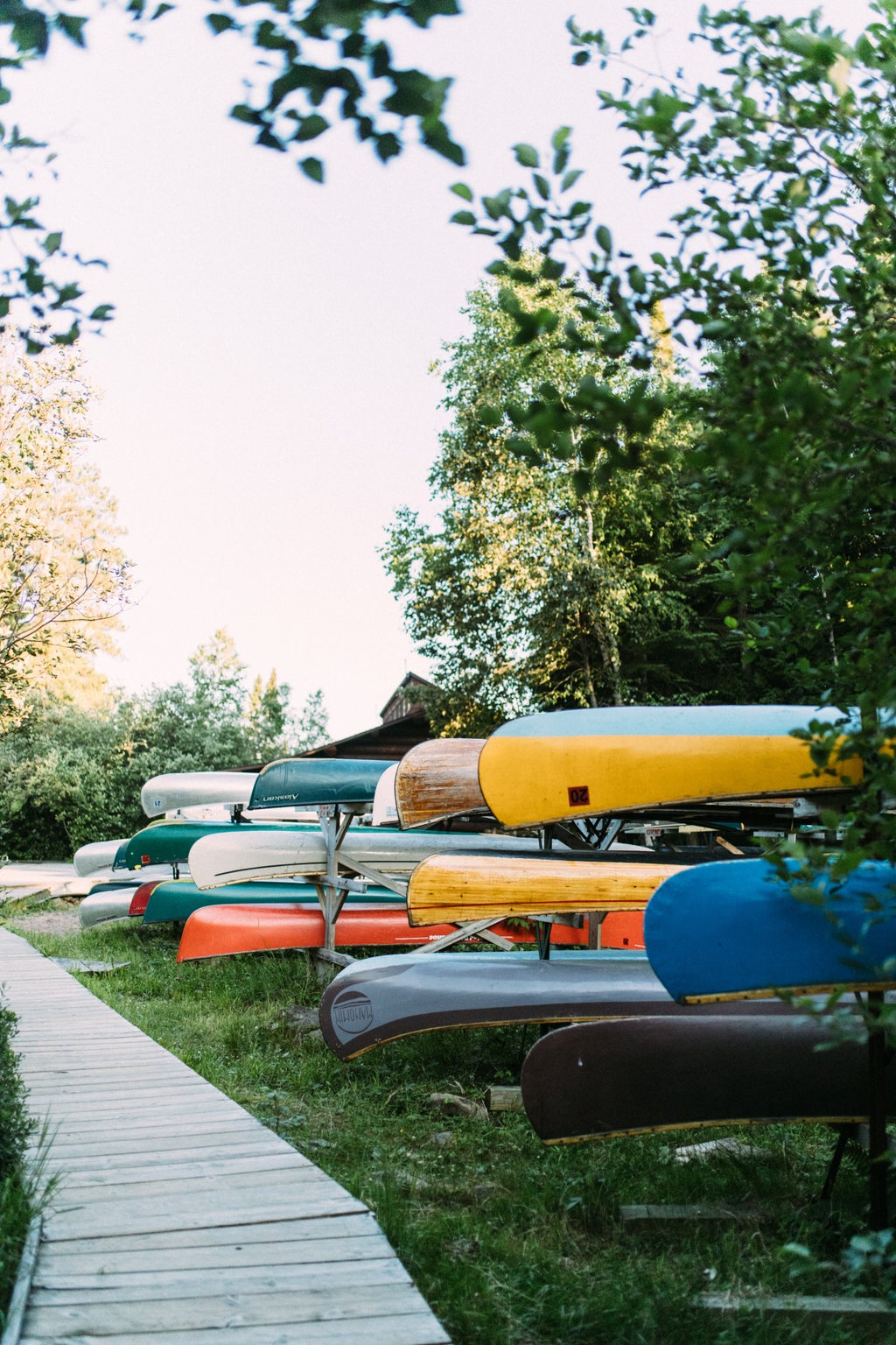 stack of canoes near boardwalk