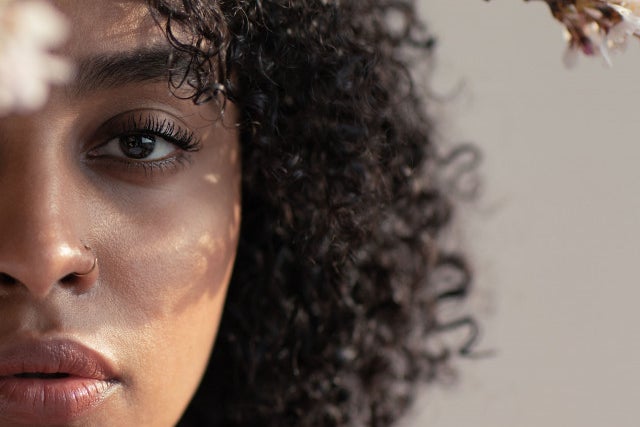 black woman with about half of her face showing