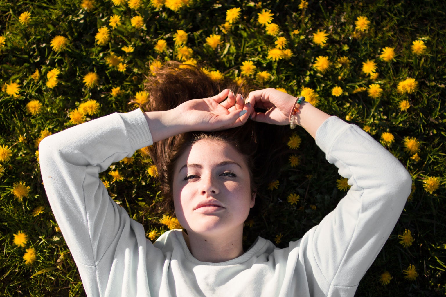 Woman laying in a field of flowers