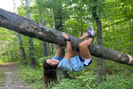 Woman swinging on a tree branch