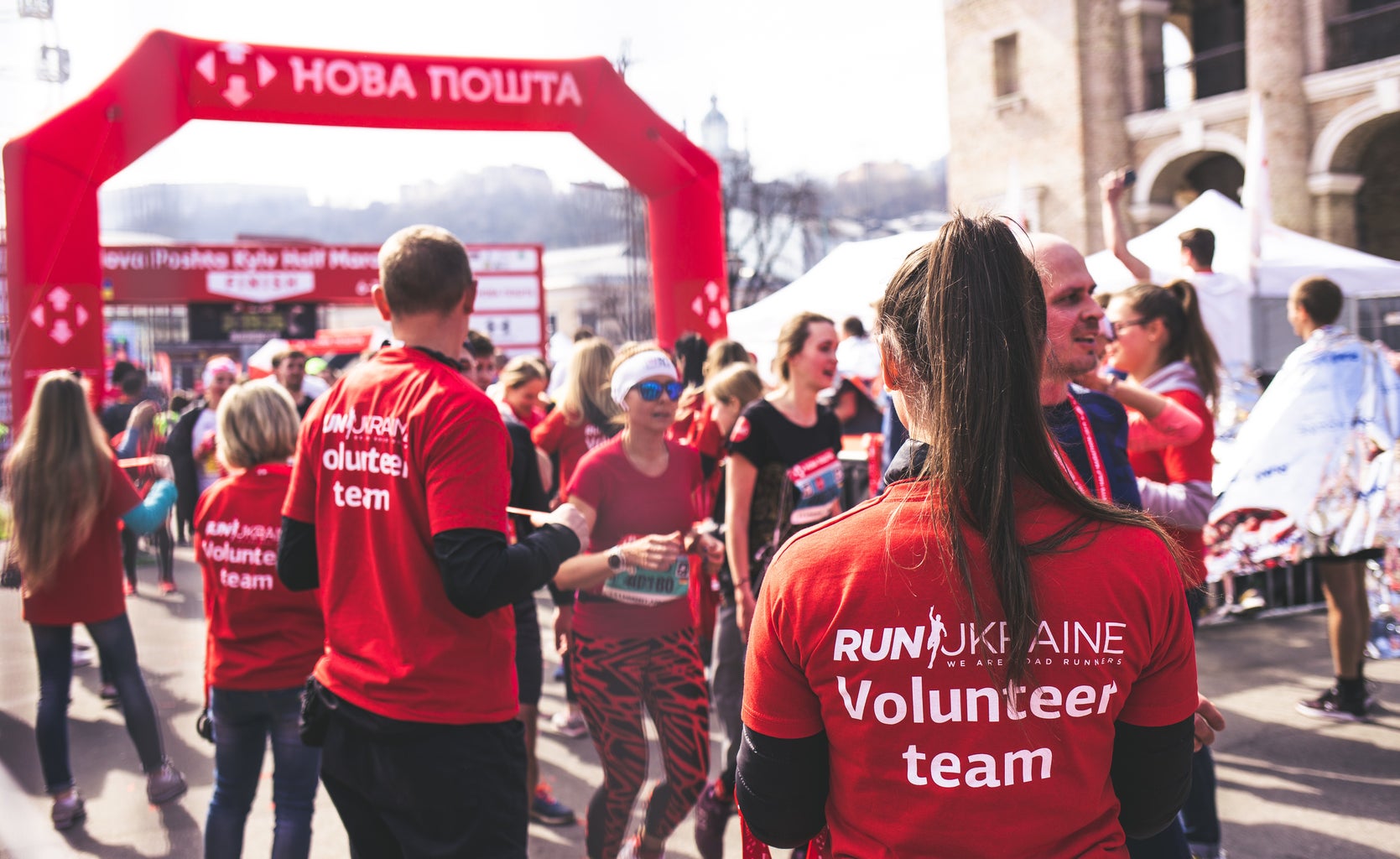 Group of volunteers in red shirts at an outdoor race
