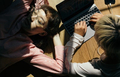 laying on floor using laptop with friend