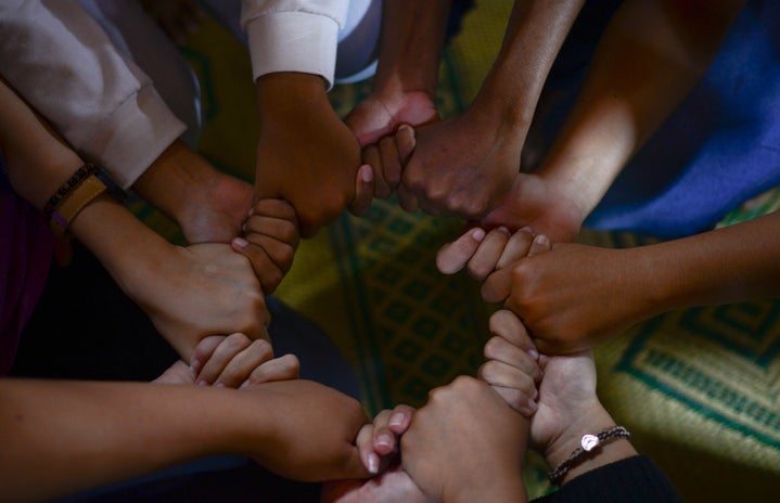 group of diverse people holding hands by Wylly Suhendra via Unsplash?width=719&height=464&fit=crop&auto=webp