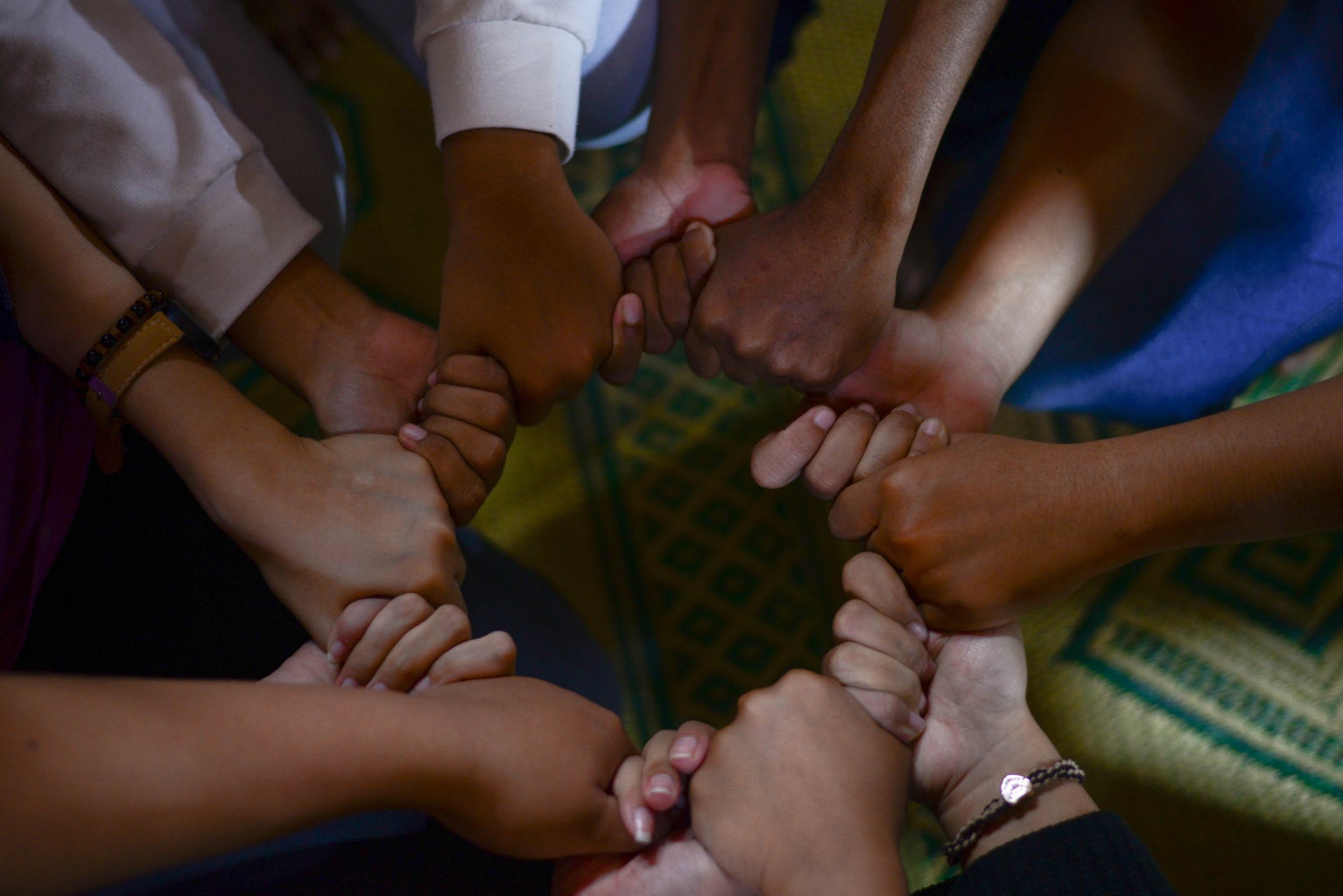 group of diverse people holding hands