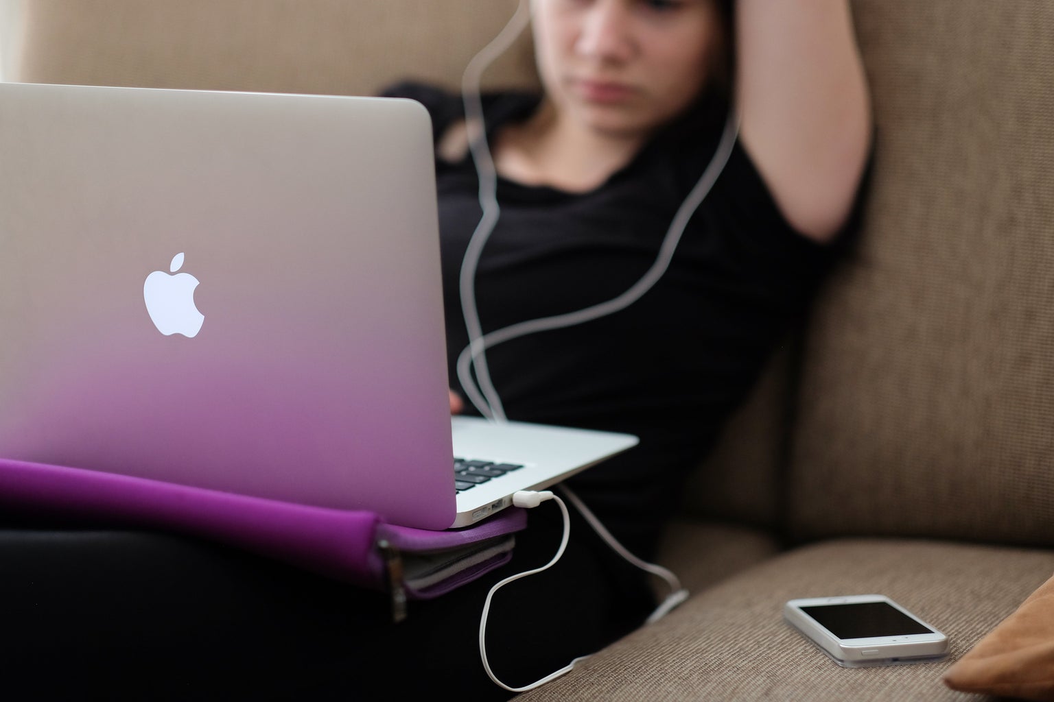 Person listening to music on laptop