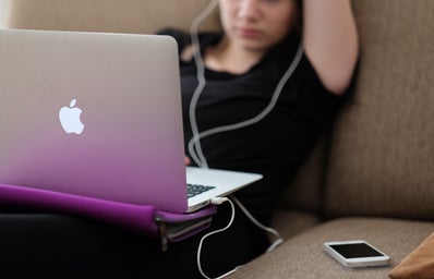 Person listening to music on laptop