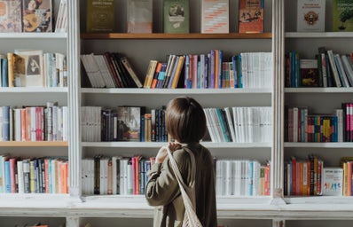 Woman browsing a book shelf