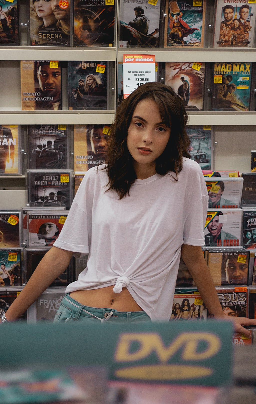 woman standing in front of movie store