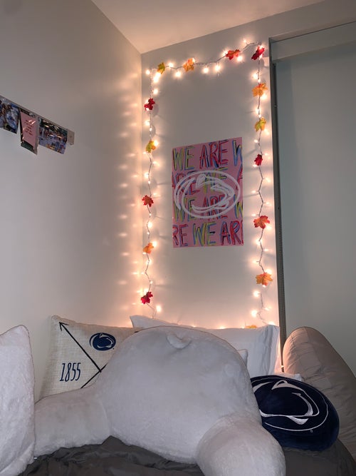 My dorm bed with string lights with leaves
