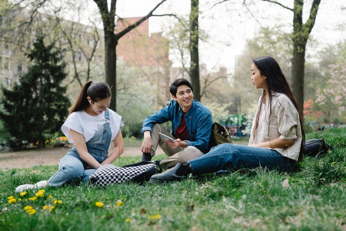 College students spending time together and studying outside.