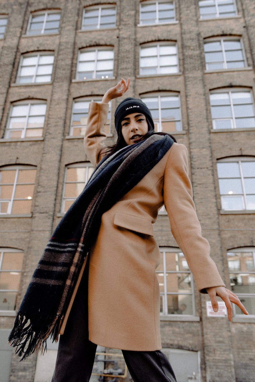 woman in brown coat, scarf and hat