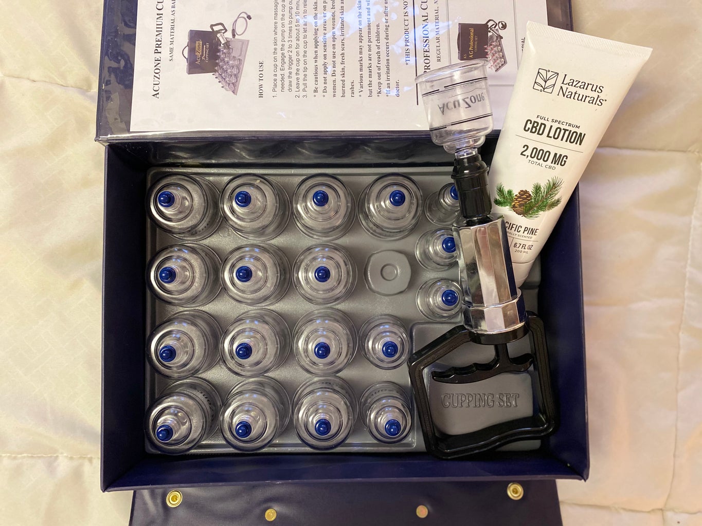 Massage cups in a box with CBD lotion.