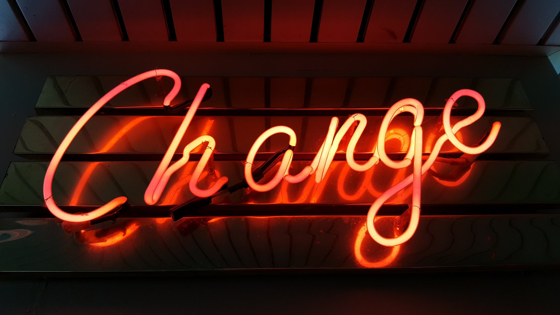 \'Change\' in an orange neon sign