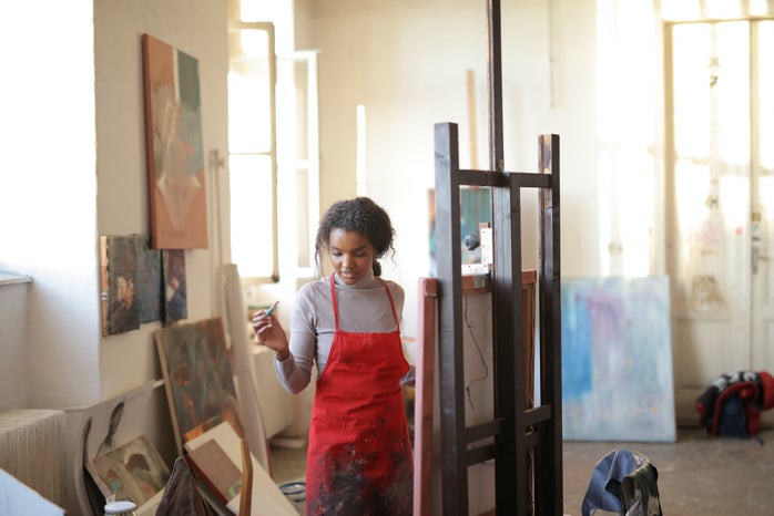 woman artist painting in studio