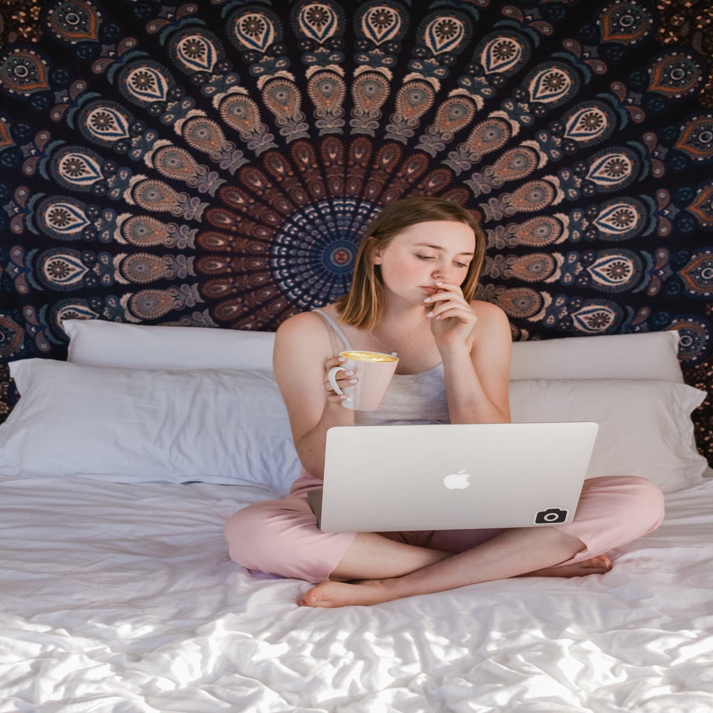 woman sitting on bed