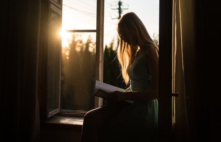 Woman reading at window by Yuri Efremov?width=719&height=464&fit=crop&auto=webp