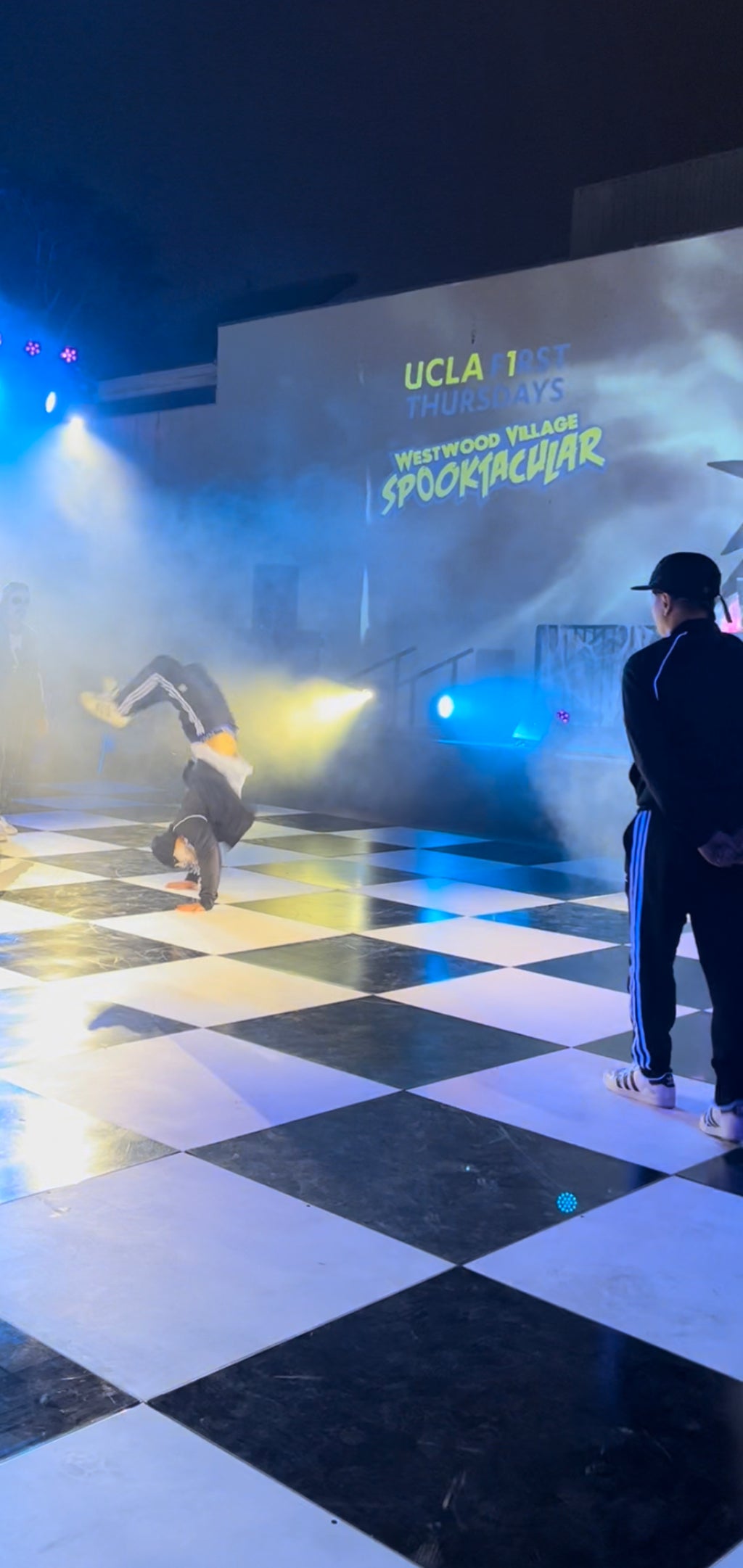 Performer doing a handstand on the dance floor.