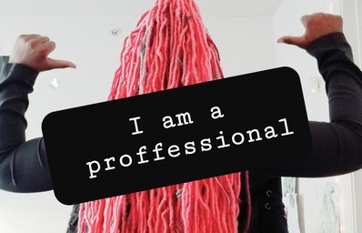 Woman with pink hair taking picture of herself with the caption \"I am a proffessional\"