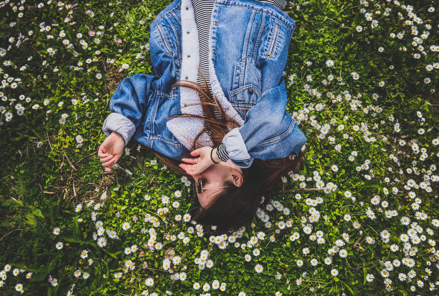 girl laying down on flowers