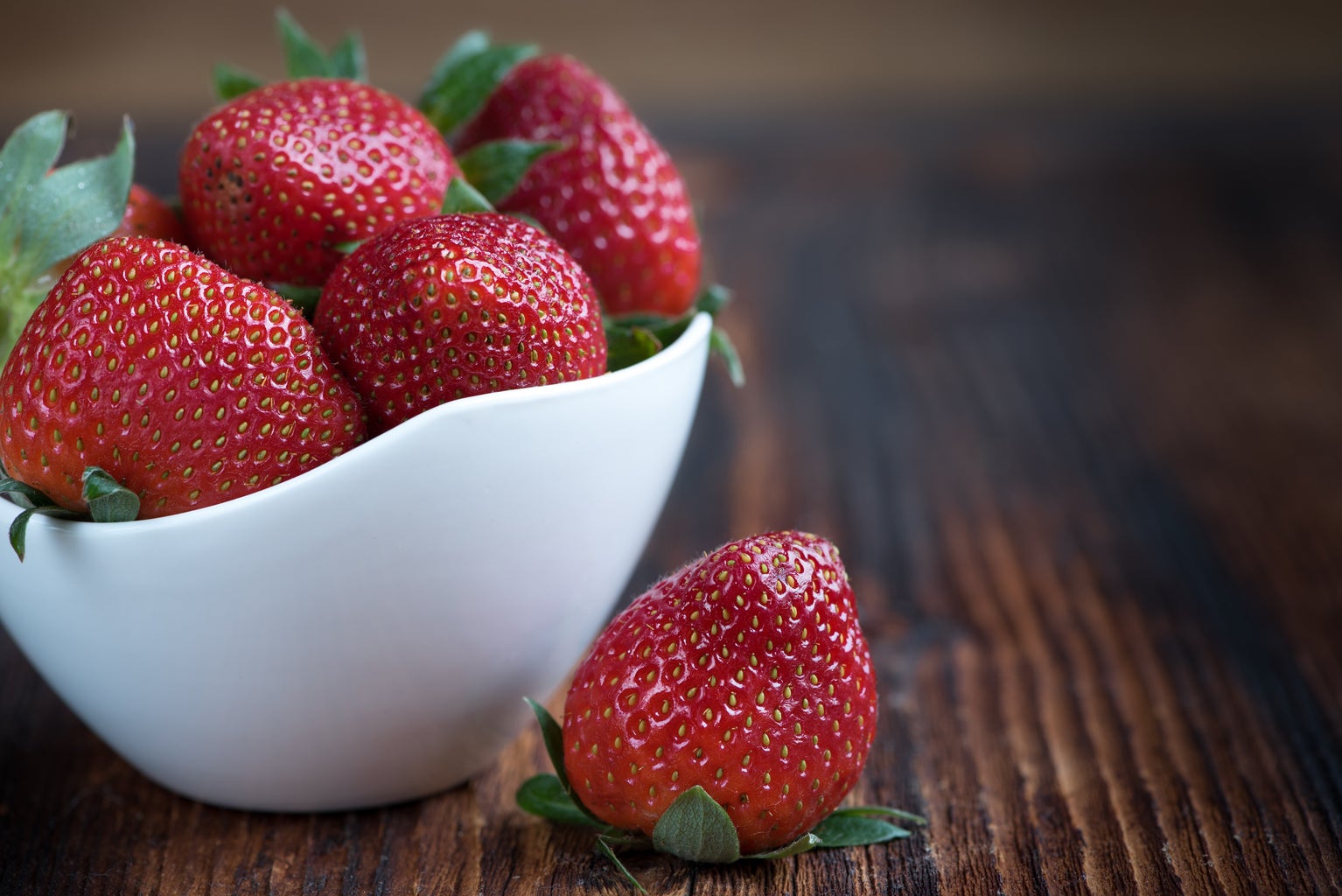 White bowl of strawberries