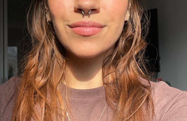 A picture of my nose, lips, shoulders, and new septum piercing