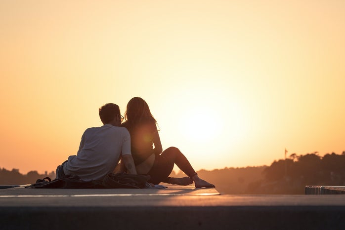 couple watching sunset by Khamko Vilaysing?width=698&height=466&fit=crop&auto=webp