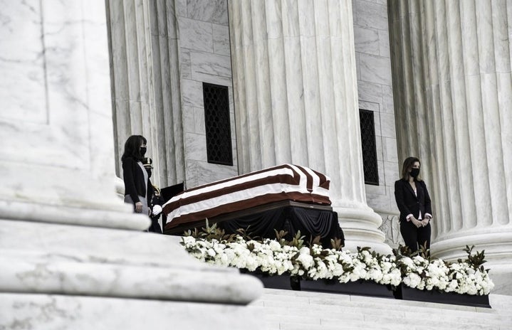 Ruth Bader Ginsburg\'s casket draped in an American flag resting in state on the capitol steps