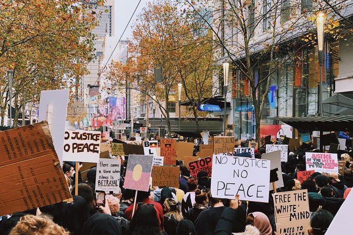 people standing on street during daytime with protest signs