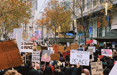 people standing on street during daytime with protest signs