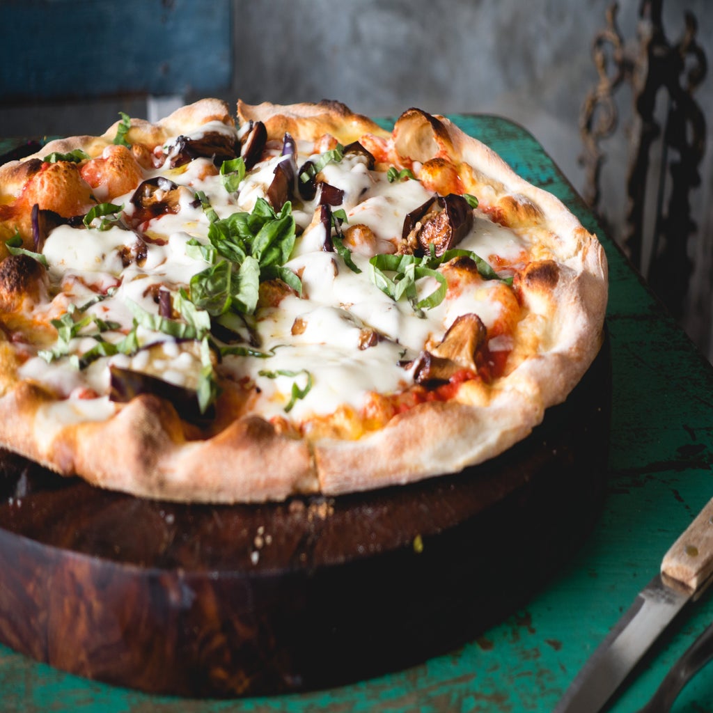 meat cheese pizza on wood plate