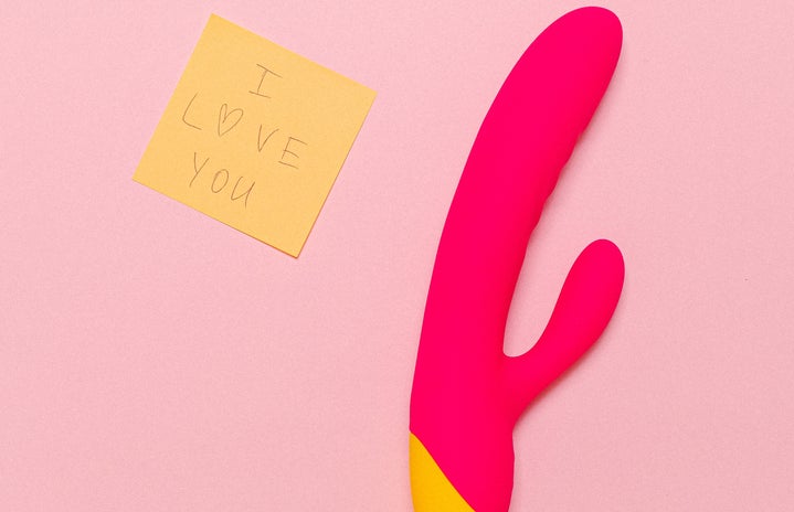 pink background with vibrator and sticky note saying I love you