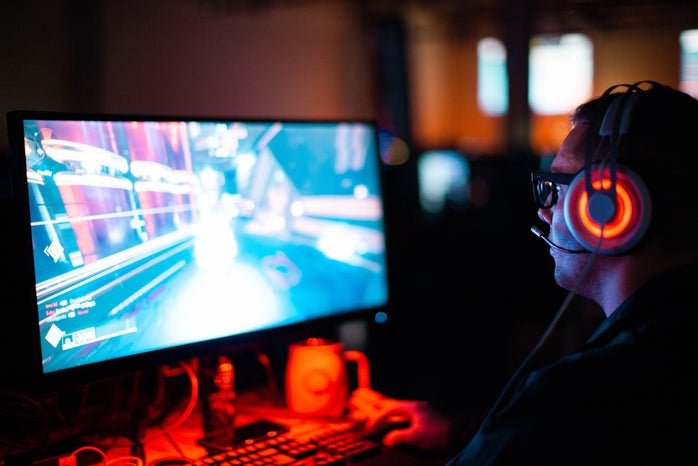 man with a headset playing a computer video game