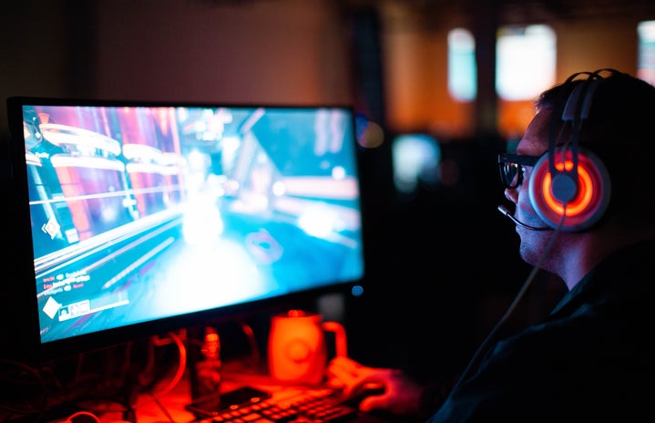 man with a headset playing a computer video game