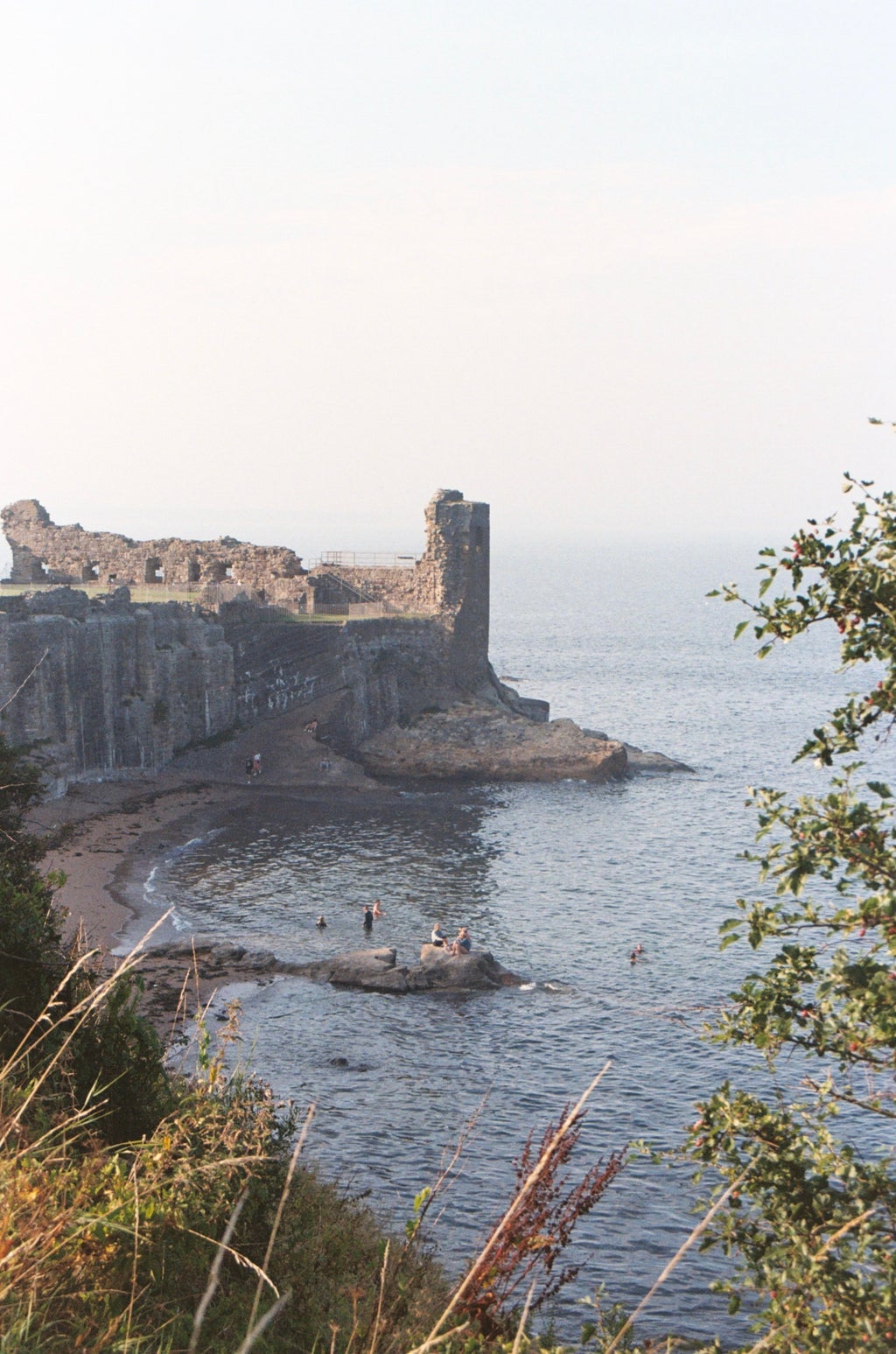 scenic outlook of castle ruins and a beach