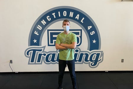 personal trainer in front of sign